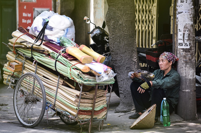 Người bán hàng rong trên phố Vương Thừa Vũ (Thanh Xuân, Hà Nội) tranh thủ nghỉ ngơi trong bóng râm.