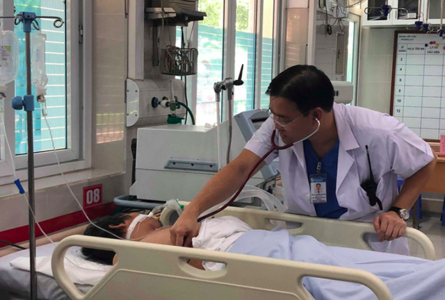 TS Nguyễn Anh Tuấn (Bệnh viện Bạch Mai) thăm khám cho người đàn ông nghi bị sốc nhiệt do nắng nóng, đưa vào viện cấp cứu sáng 4/7. Ảnh: V.Thu