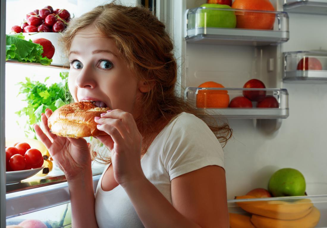 a-woman-snacking-from-the-fridge