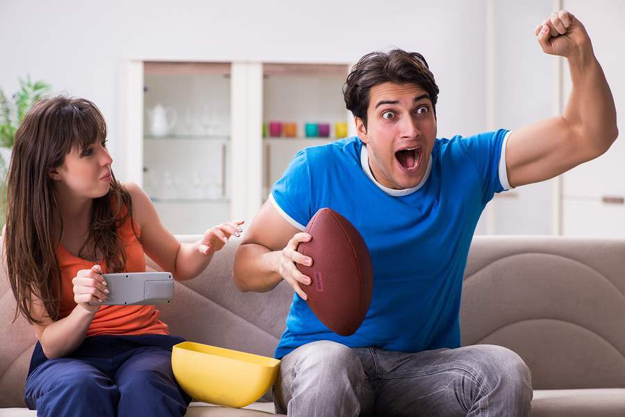 man-woman-watching-football