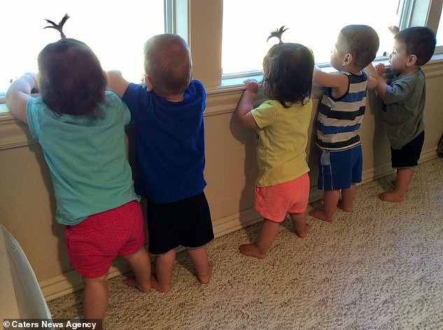 16153212-7255955-The_five_children_peering_out_of_the_window_at_home_pictured_The-a-26_1563364639822