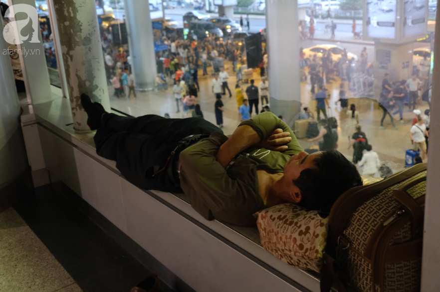 Sân bay Tân Sơn Nhất đông nghẹt: Trẻ em ngủ gục, người lớn cầm sẵn hoa chờ đón Việt kiều về nước ăn Tết - Ảnh 5.