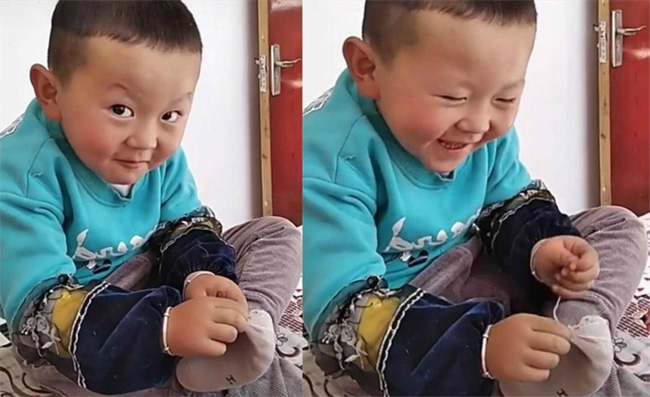Cậu bé gây chú ý khi tự ngồi khâu tất, biểu cảm rất đáng yêu - Ảnh 2. Cậu bé gây chú ý khi tự ngồi khâu tất, biểu cảm rất đáng yêu - Ảnh 2.