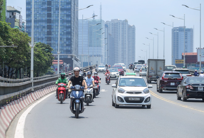 Người Hà Nội trùm kín mít khi ra đường trong ngày đầu tiên của đợt nắng nóng  - Ảnh 1.