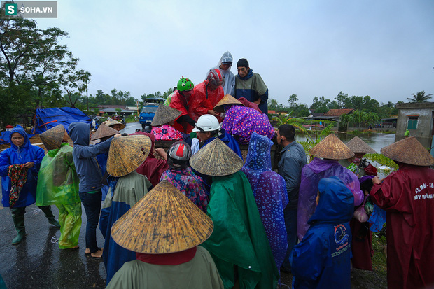 Ảnh: Người phụ nữ ở Quảng Bình lao ra dòng nước lũ xin đồ ăn cho mẹ già bật khóc khi được cứu hộ khỏi ghe lật - Ảnh 7.