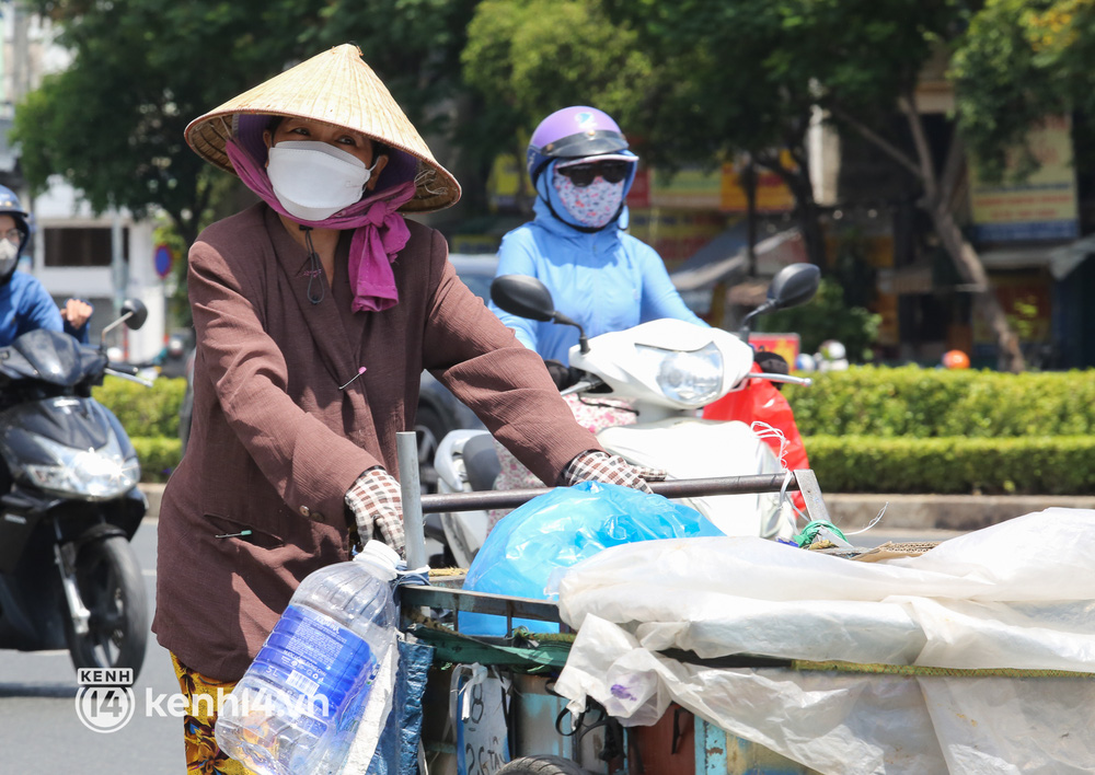 Người dân TP.HCM vật vã dưới nắng nóng hầm hập 34 độ C, ai cũng rát mặt khi ra đường - Ảnh 9.